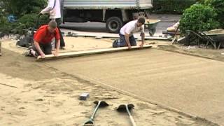 Screeding a paving laying course [upl. by Aehsrop]